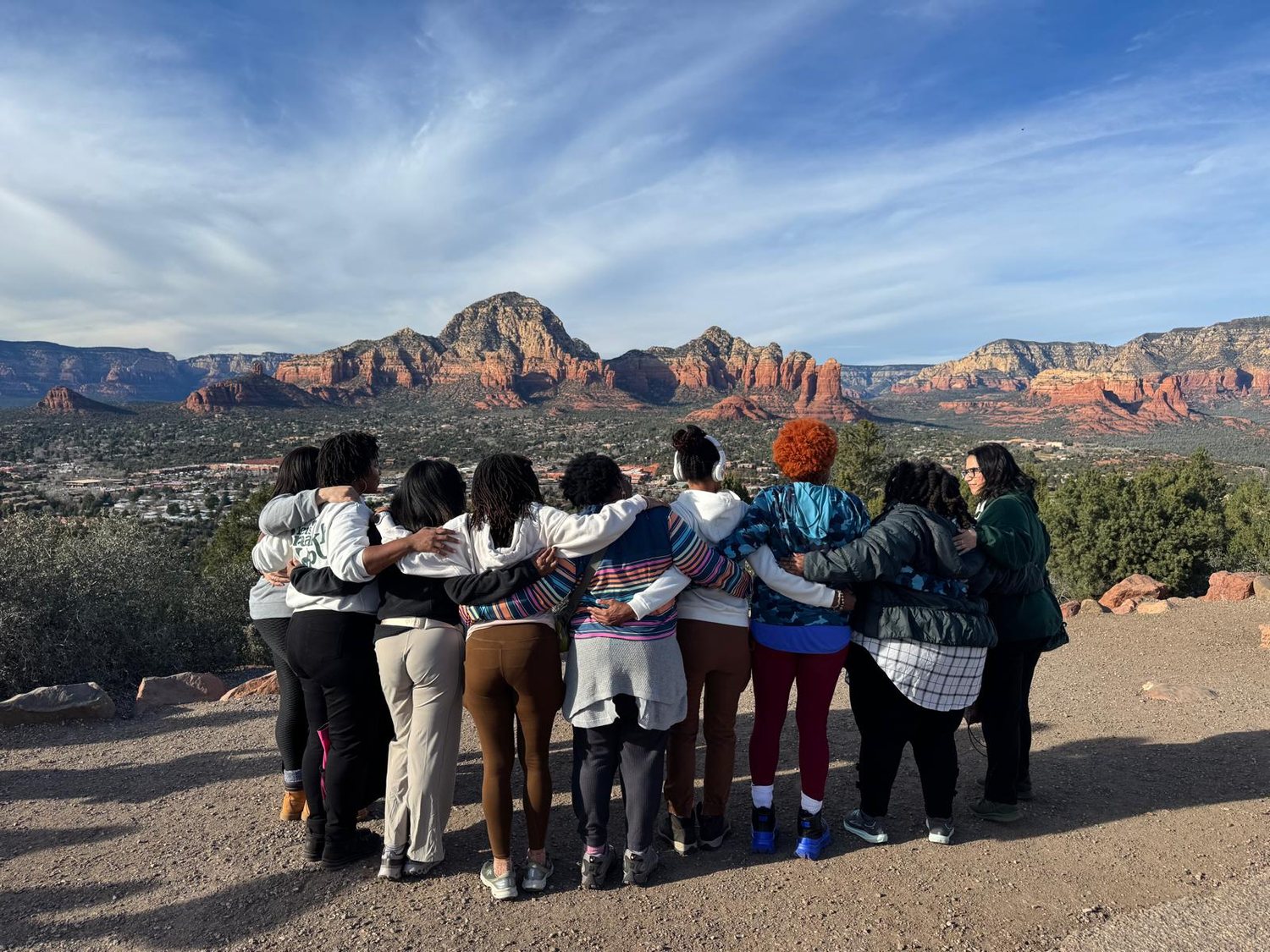 The group embracing at a Sedona overlook